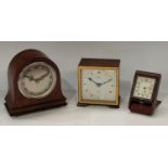 A mahogany Elliot clock, 11cm; another domed miniature mantel clock; a folding travel clock (3)