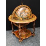 A mid-20th century novelty floor-standing drinks cabinet, as a globe, spirally turned supports,