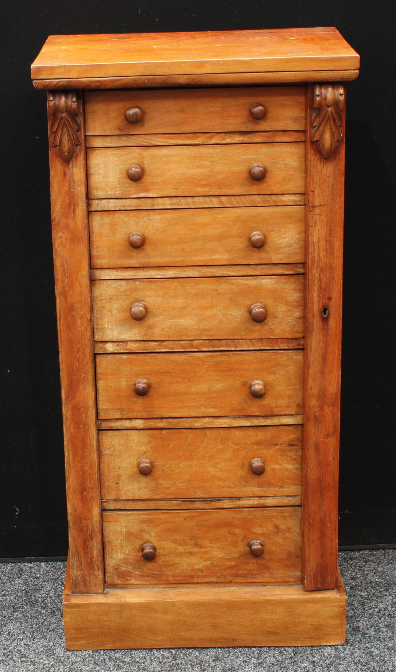 A Victorian walnut Wellington chest, rectangular top above seven graduated drawers, restrained by