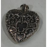 A silver heart shaped scent bottle
