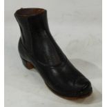 Advertising - a late 19th century teracotta counter top match striker as a lady's boot, Fred Henry