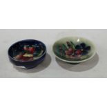 A Moorcroft Orchid pattern circular pin tray, 8cm diam; another, Summer Flowers, 10cm diam,