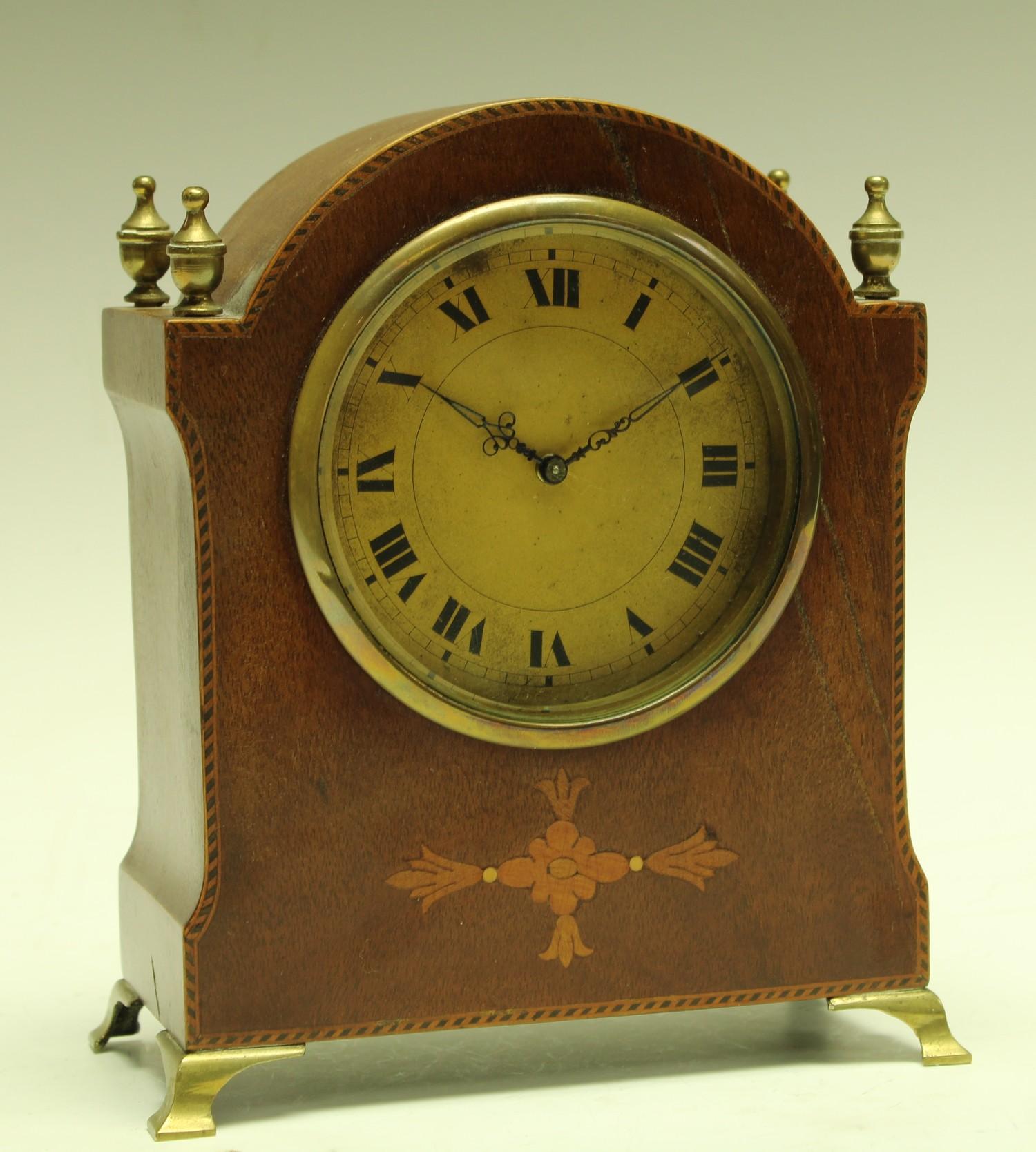 An Edwardian mahogany inlaid mantel clock