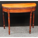 A George III mahogany demilune tea table, hinged top with reeded edge, above a deep frieze, turned