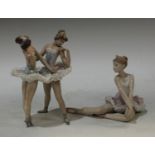 A Lladro model of a ballet dancer, 13cm high; another a pair of ballet dancers, 20cm high, printed