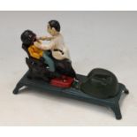 A novelty cast iron money bank modelled as a dentist and figure seated in the chair, stamped to