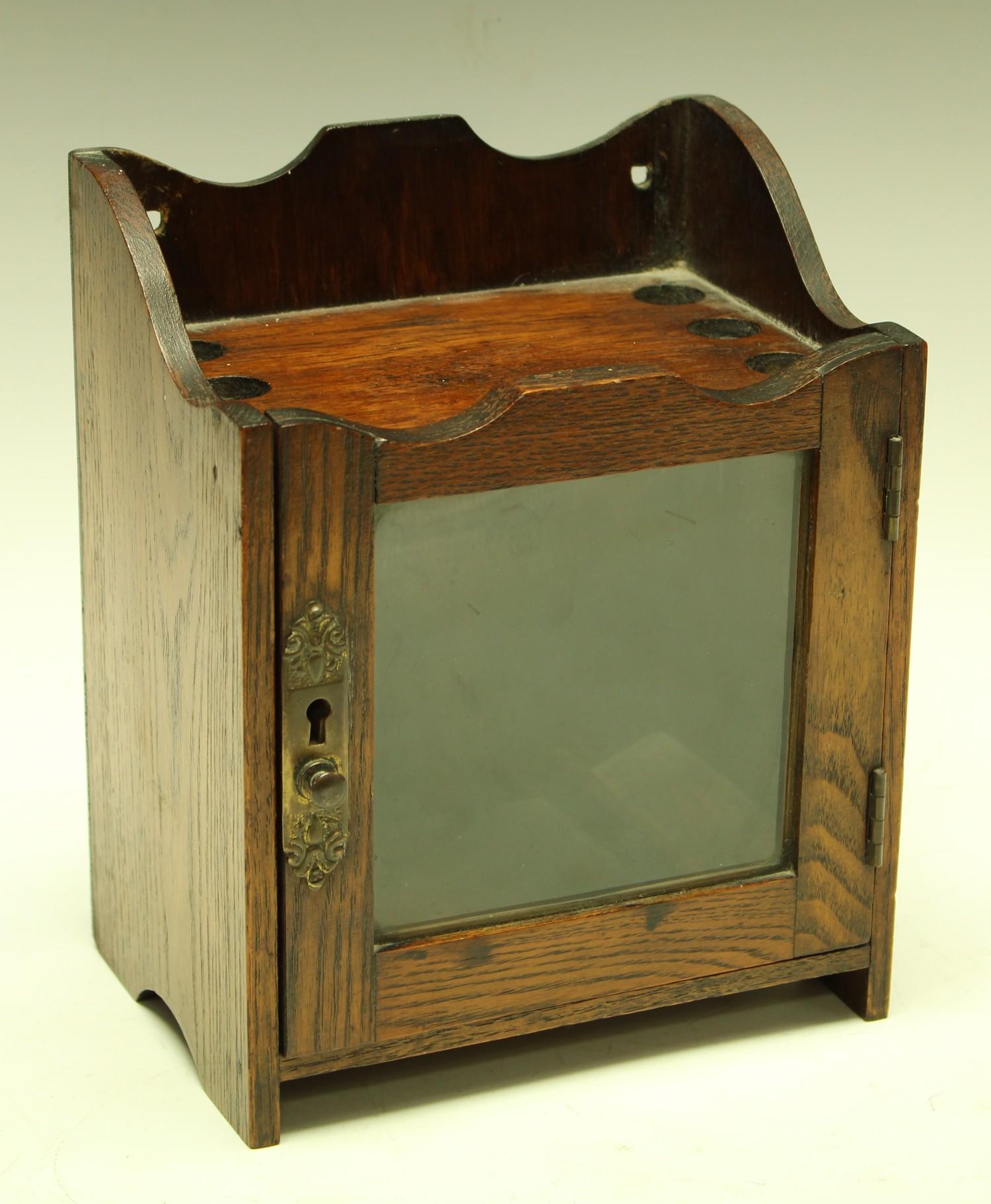 An Edwardian oak smoking room cabinet, c.1905