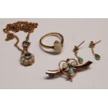 An 18ct gold opal ring, 3g; a 9ct gold opal and sapphire pendant and chain, an opal shamrock brooch,
