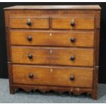 A late George III oak and mahogany chest, slightly oversailing rectangular top above a small central