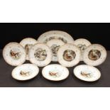 A Limoges game service, comprising oval platter and ten plates, printed with assorted varieties of