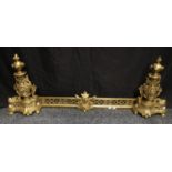 An early 20th century Rococo style three piece pierced brass adjustable fender