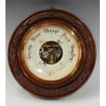 An aneroid wall barometer, carved circular mahogany frame, 33cm diameter