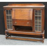 An early 20th century oak lead-glazed bookcase bureau, c.1930. 122cm wide, 113cm high.