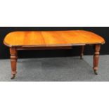 A Victorian mahogany extending dining table, discorectangular top with moulded edge, turned legs,