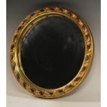 A circular convex wall mirror, gold frame