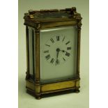 A 19th century carriage clock, shaped brass case