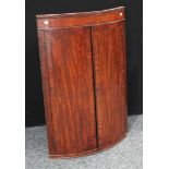 A George III mahogany bow-front corner cupboard, 104cm high