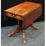 A Regency mahogany Pembroke table, rounded rectangular top with fall leaves, above a single frieze