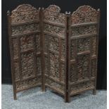 A 19th century Indian carved wood three fold screen, 101cm high.