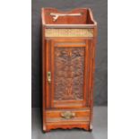 An early 20th century carved oak smoker's cabinet, pierced brass gallery, fitted for pipes with