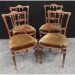 A set of four Victorian mahogany side chairs, stuffed over upholstery, tapered fluted legs.(4)