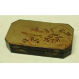 A Japanese export lacquer canted rectangular box, hinged cover decorated with a monumental lanscape,