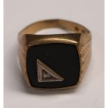 A gold signet ring, set with a diamond chip and black enamel, 3.2g, marked 333