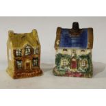 A 19th century cottage money box, with blue roof, sponged in green and pink, 10.5cm high, c.1820;