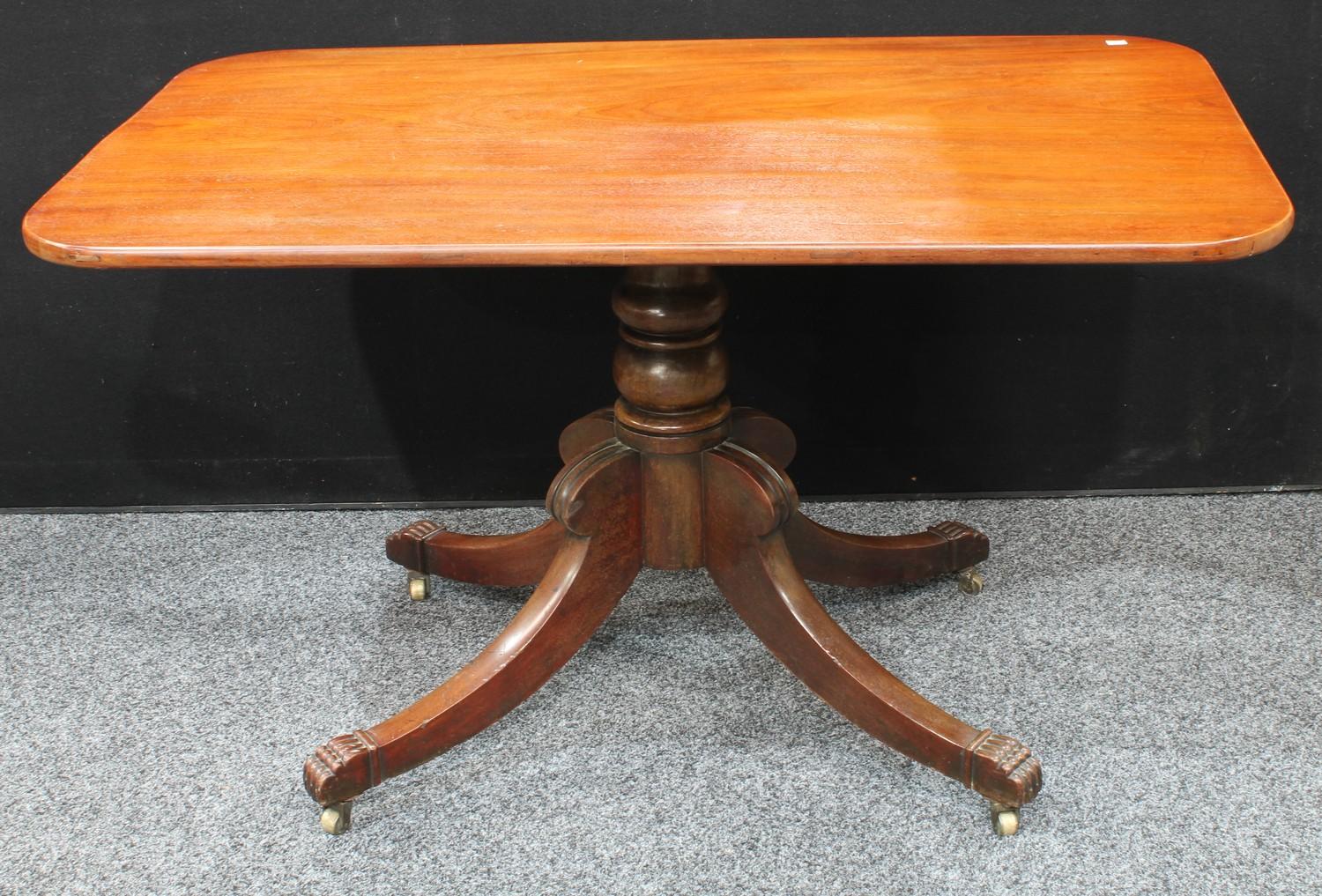 A Regency mahogany rectangular breakfast table, tilting top, turned column, sabre legs terminating