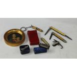 A miniature Owzat game, boxed; a miniature harmonica, boxed; a miniature pocket knife; others; a