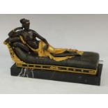A Canova bronze statue of a reclining scantily clad empress, rectangular marble base.