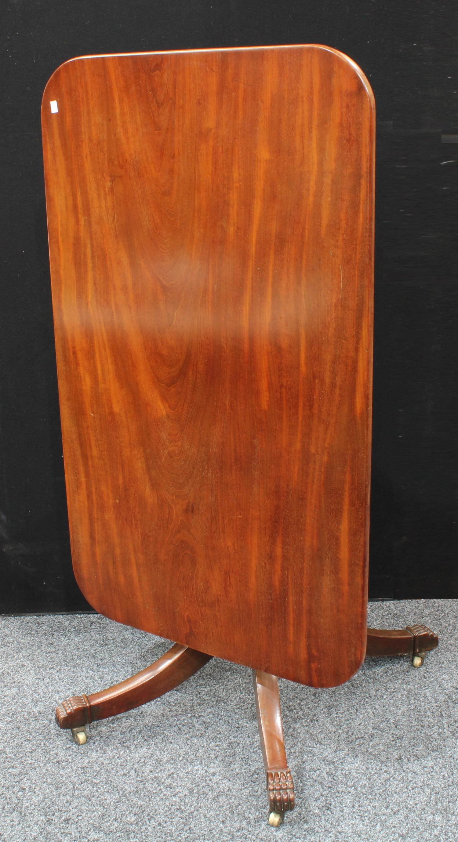 A Regency mahogany rectangular breakfast table, tilting top, turned column, sabre legs terminating - Image 2 of 2