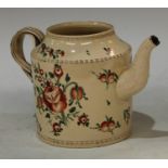 An 18th century Leeds creamware cylindrical teapot, painted with stylised peonies and tulips,