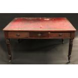 An early Victorian mahogany library table, rounded rectangular top with inset writing surface, above