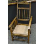 An Arts and Crafts style oak reclinable armchair.