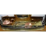 A Victorian brass fender; a brass trivet; a brass companion set; a copper kettle; toasting forks