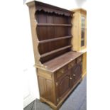 An oak dresser by Frank Pratt, three shelves to top, three drawers over three fielded panel doors to