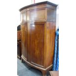 A Victorian mahogany bowfront hall robe, outswept cornice, two door cupboard over two door robe,