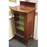 An Edwardian mahogany bowfront cabinet, crossbanded gallery and top, glazed door enclosing lined
