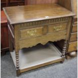 An oak hall table, moulded top, nulled frieze, two short drawers, pierced brass batwing escutcheons,