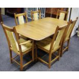 An Ercol Golden Dawn ash refectory style extending dining table, four dining chairs with padded
