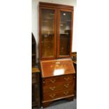 An Edwardian mahogany bureau bookcase, two glazed doors enclosing adjustable shelving, fall front