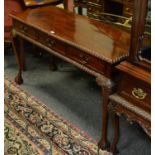 A teak centre table, rectangular top, gadrooned border, three short drawers to frieze, faux