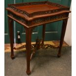 A modern teak Chippendale style silver table, serpentine rectangular top, pierced gallery and