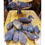 A folk art wood pigeon decoy, with wings spread; another wings folded; other Italian plastic