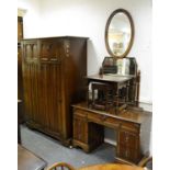 A Jacobean style double wardrobe with linenfold paneling; a conforming pedestal dressing table; `two