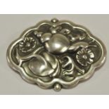 A Georg Jensen silver cartouche shaped brooch depicting a snail amid foliage stamped 279 Sterling
