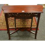 A reproduction teak hall table, shaped and moulded top, pierced and shaped frieze.