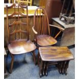 An Ercol spindle back open arm chair; another ladder back with shaped plats; a nest of three