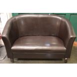 A brown faux leather two seat sofa. 81cm high x 125cm wide x 70cm deep.